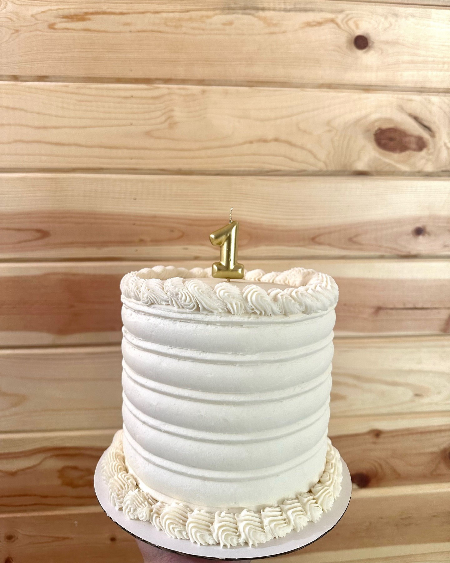Small smash cake — ribbed buttercream with a gold '1' candle, perfect for first birthdays and gender reveals
