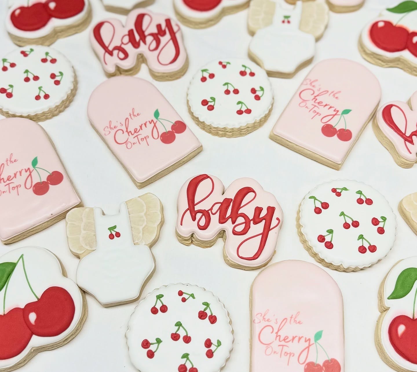 Cherry on Top baby shower cookies — pink and red cherries